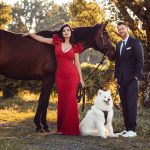 newly engaged couple posing with their horse and dog