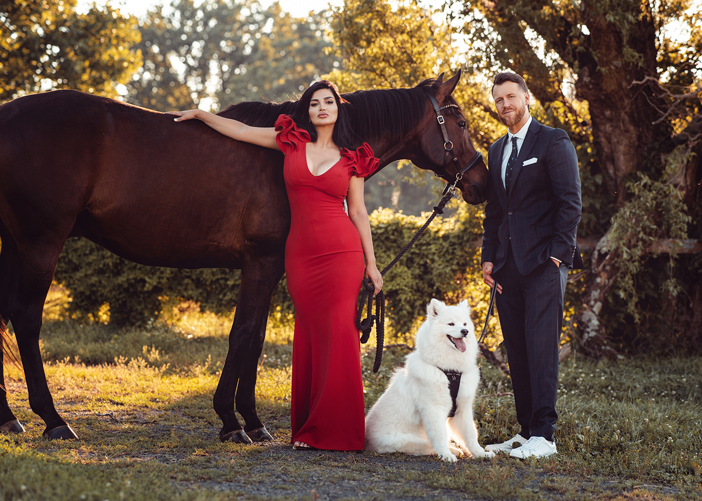newly engaged couple posing with their horse and dog