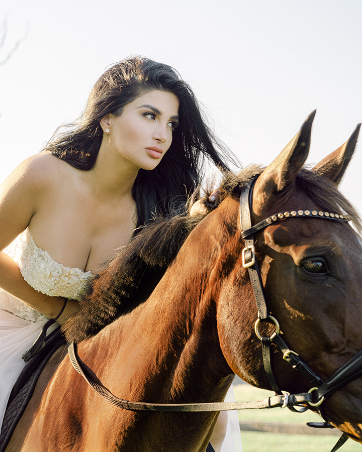 equestrian mounted on her bay horse strapless white dress 