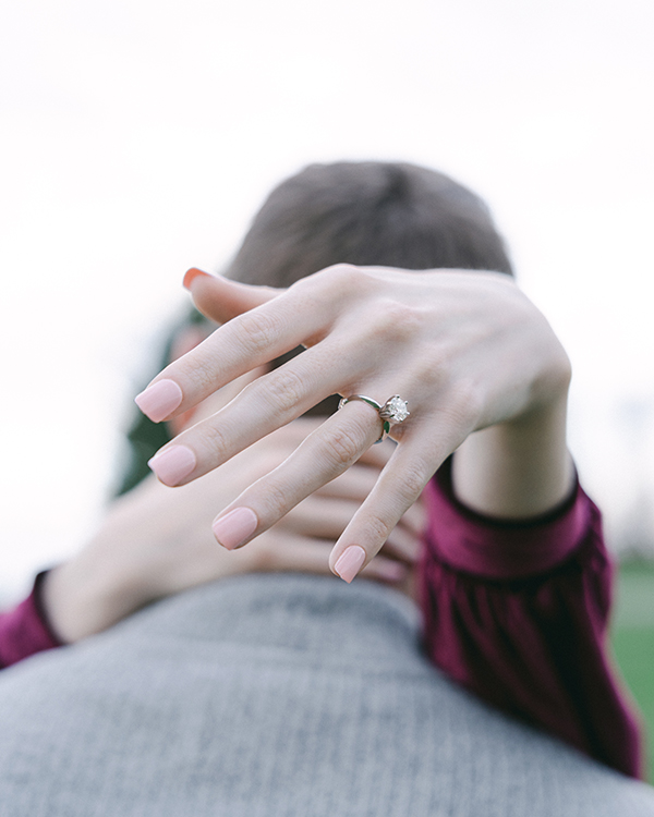 close up of engagement ring on hand