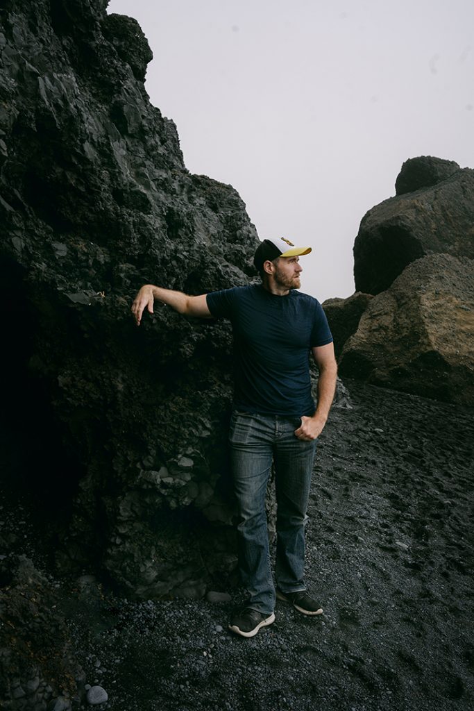 man posing on the basalt rocks in Iceland