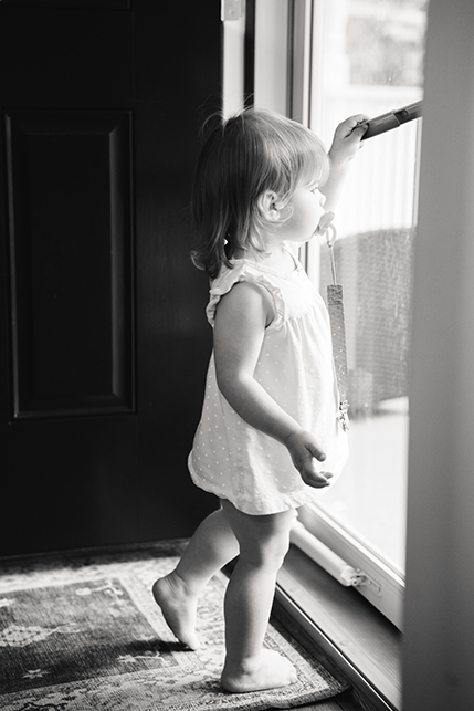 toddler looking out a window