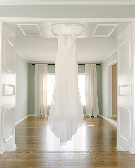 wedding dress hanging in a room