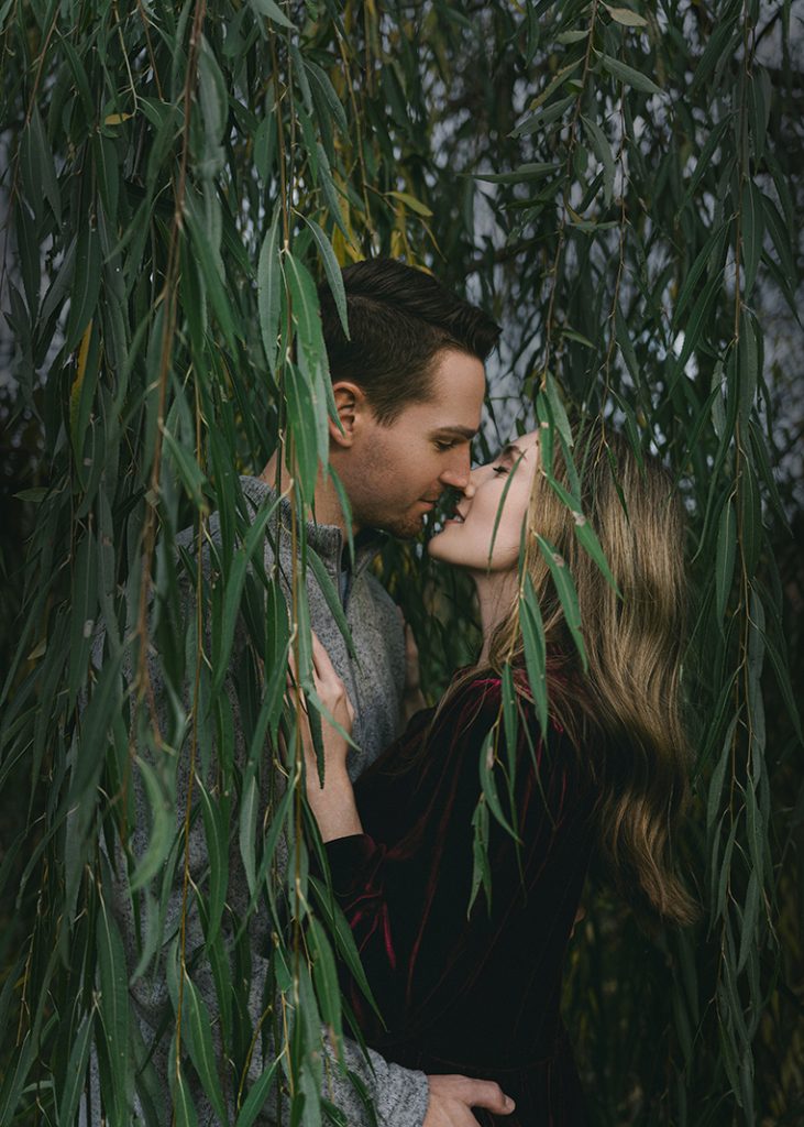 couple surrounded by vines
