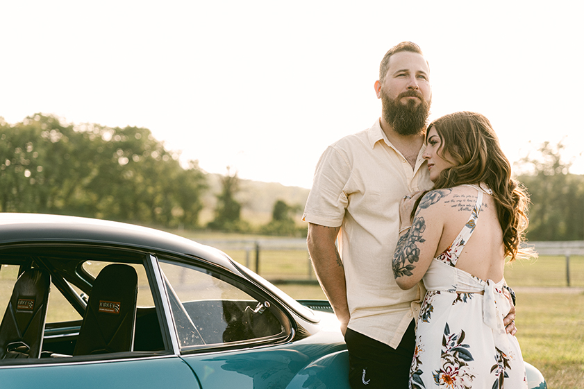 couple together leaning on a classic car