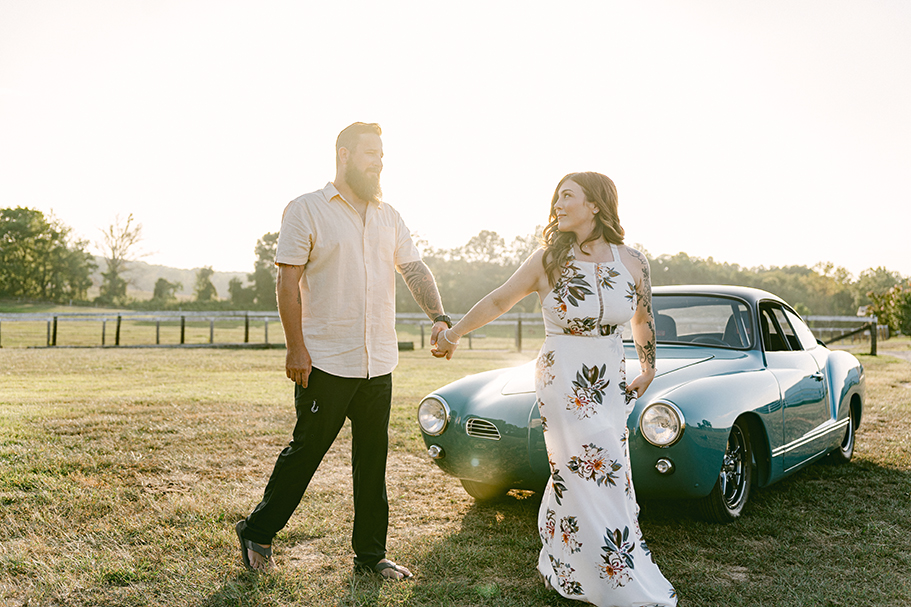 couple walking in front of classic car in the sunlight