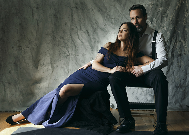 man and woman posing dramatically together in a studio setting